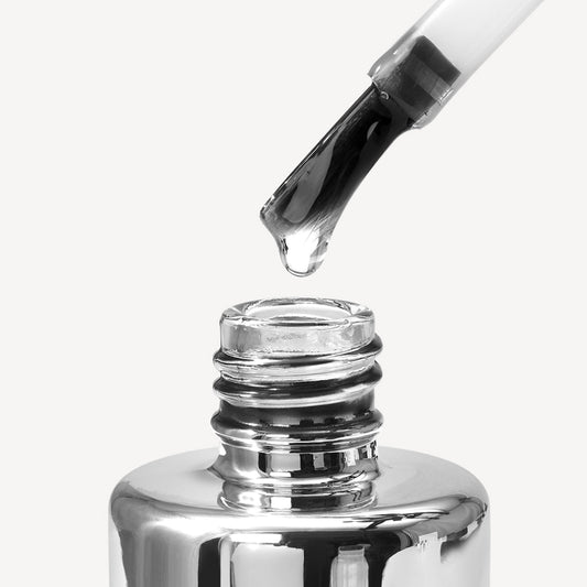 Top coat on the brush over the bottle – glossy seal for gel nails